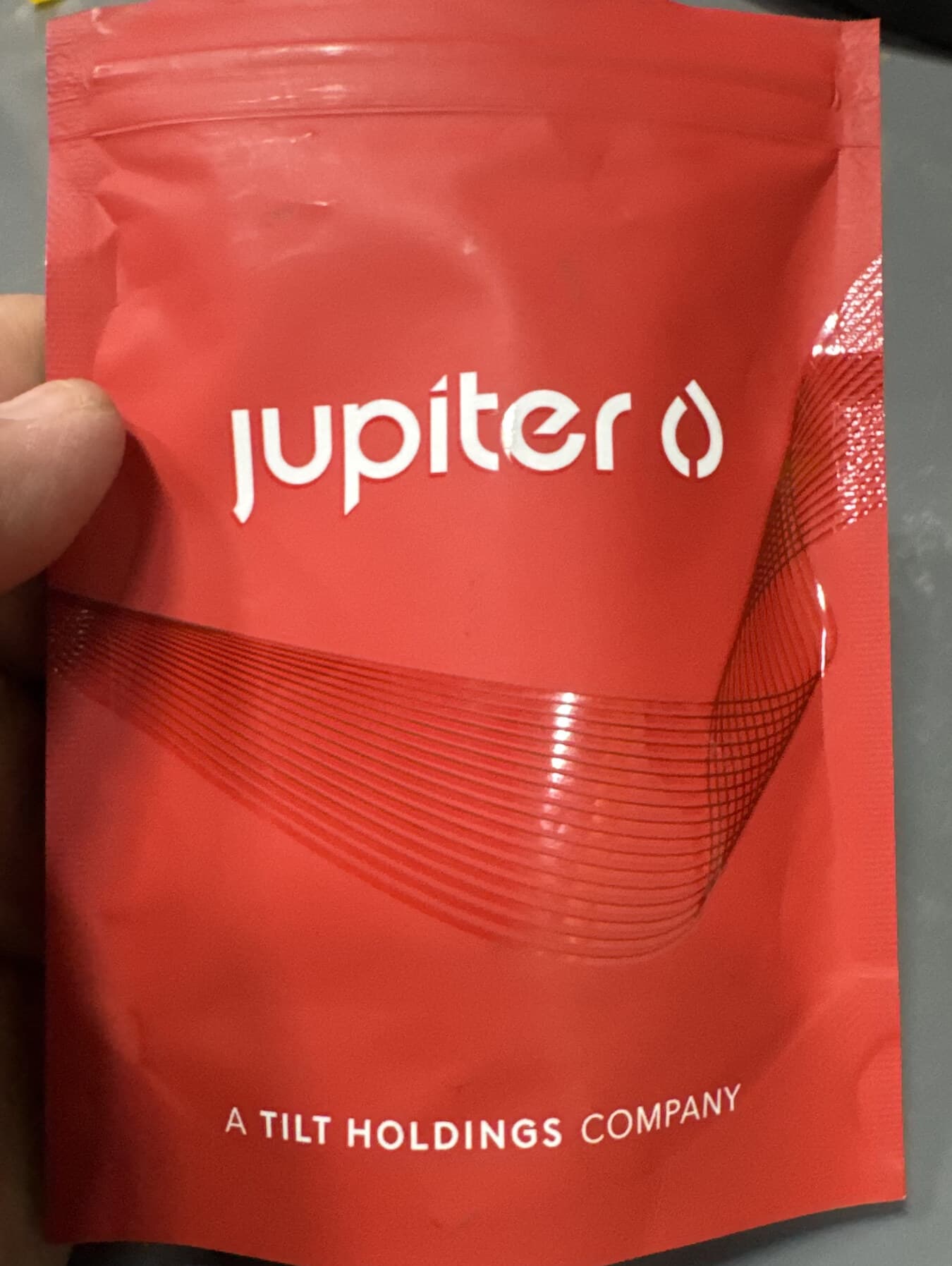 A partner brand's high-gloss, child-resistant mylar pouch — packed and heat-sealed to spec on our line.